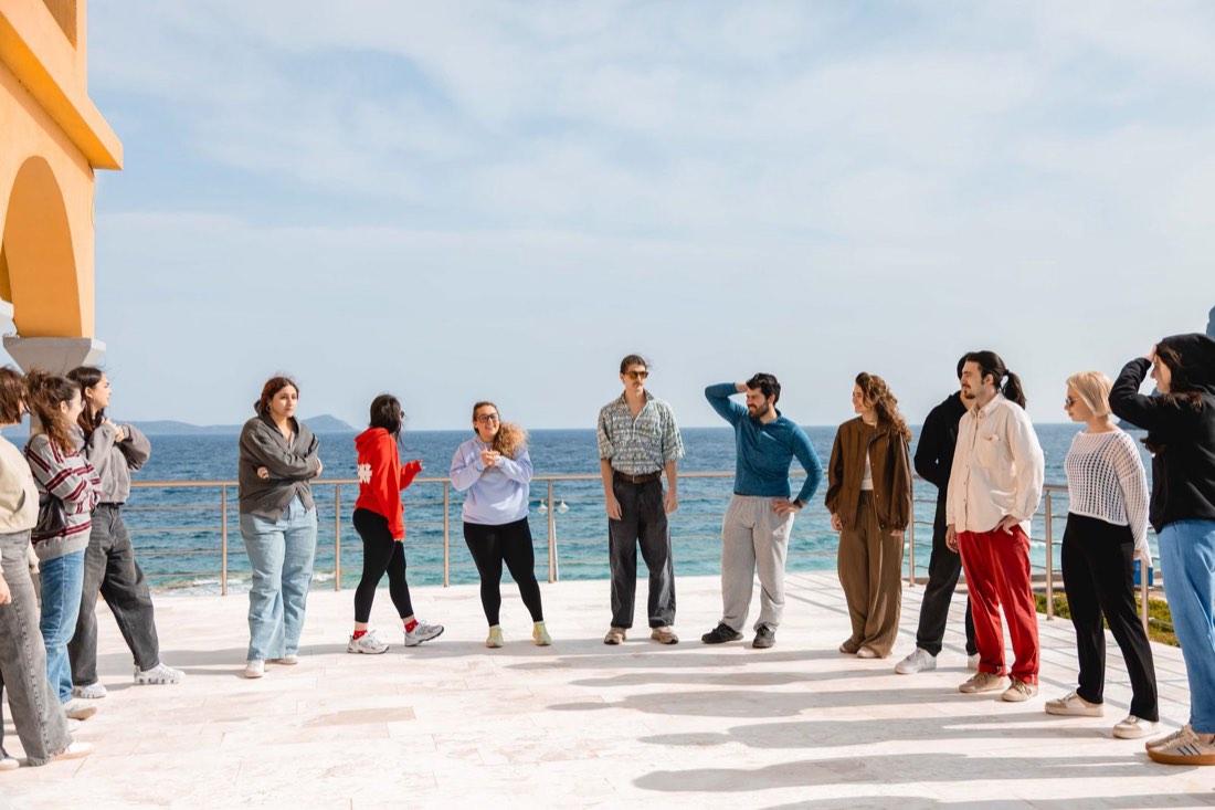 Participants in a circle on the seaside terrace during the first activities