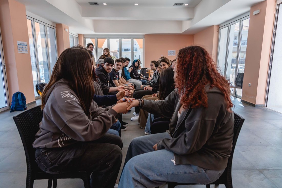 Ice breaker game with participants holding hands in a circle