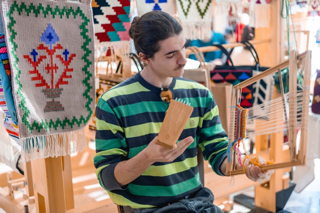 A participant learning to use the weaving comb